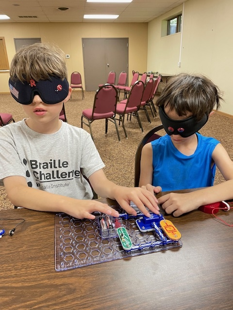 campers in braille class exploring circuit boards