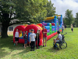 campers outside large inflatable obstqacle course
