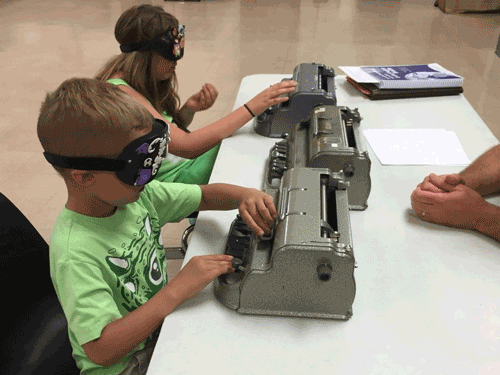 Mykell and Brook exploring and learning to use a Perkins Braille Writer